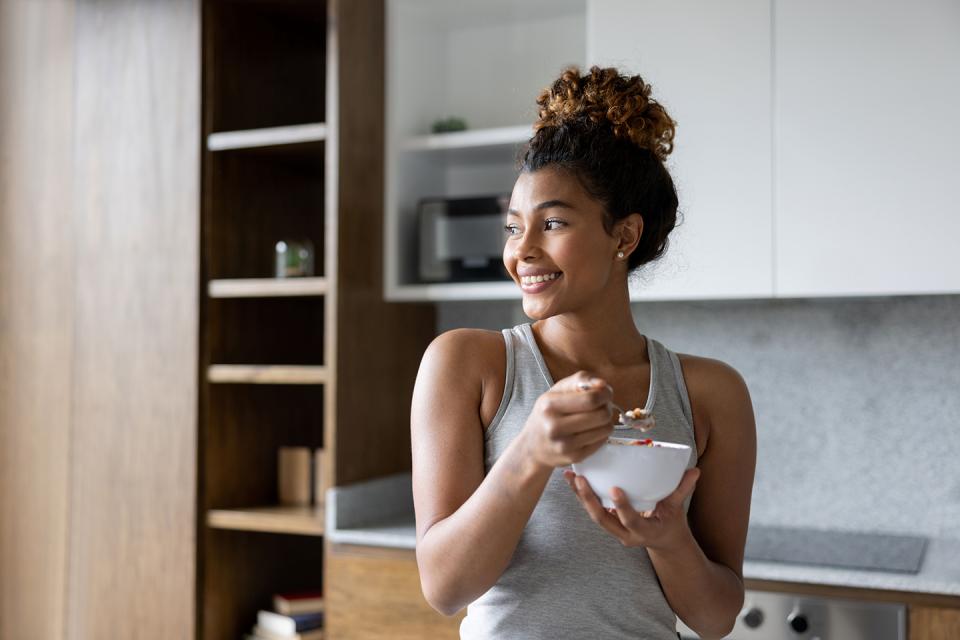 Woman eating a bowl of yogurt