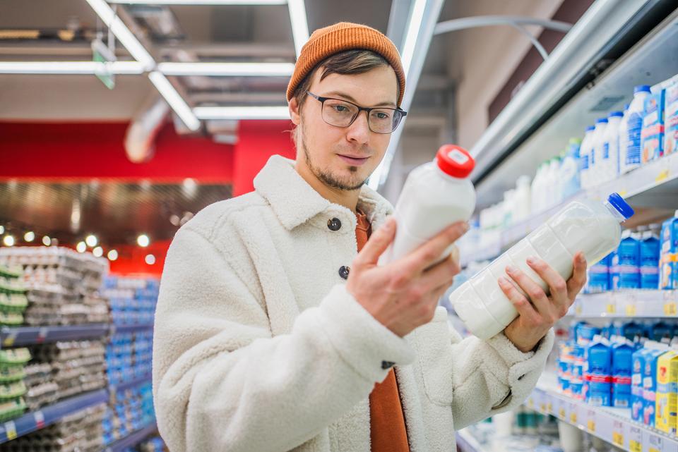 man reading a milk label