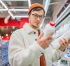 Man reading a milk label