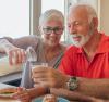 Older couple, woman pouring milk